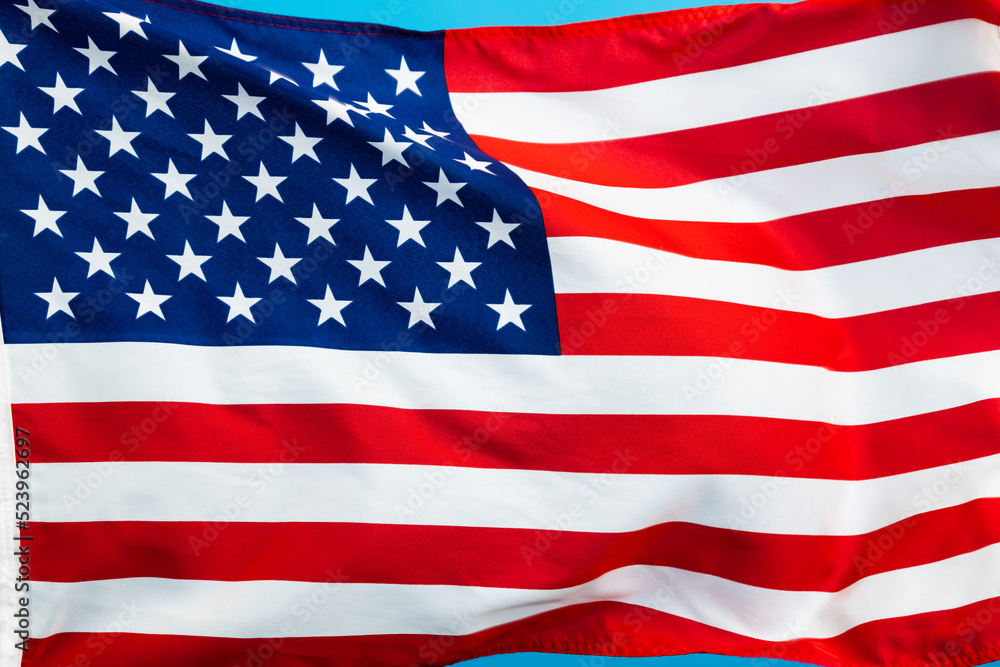 Fototapeta premium American flag waving on blue background