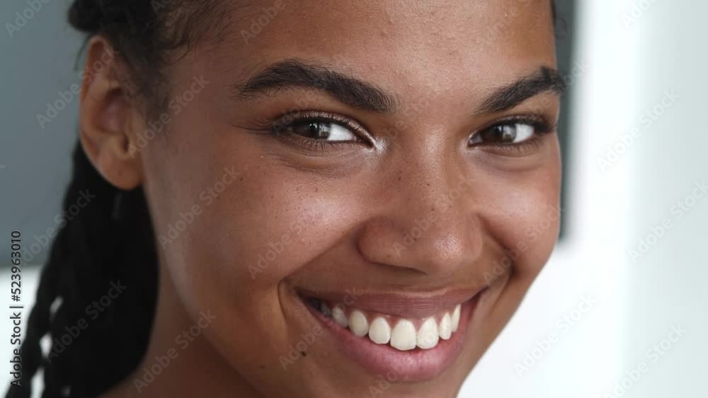 Mysterious charming seductive young multi-ethnic woman mysteriously looks away and smiles sweetly with a beautiful toothy smile looking at the camera. Mysterious charming seductive young multi-ethnic woman mysteriously looks away and smiles sweetly with a beautiful toothy smile looking at the camera.