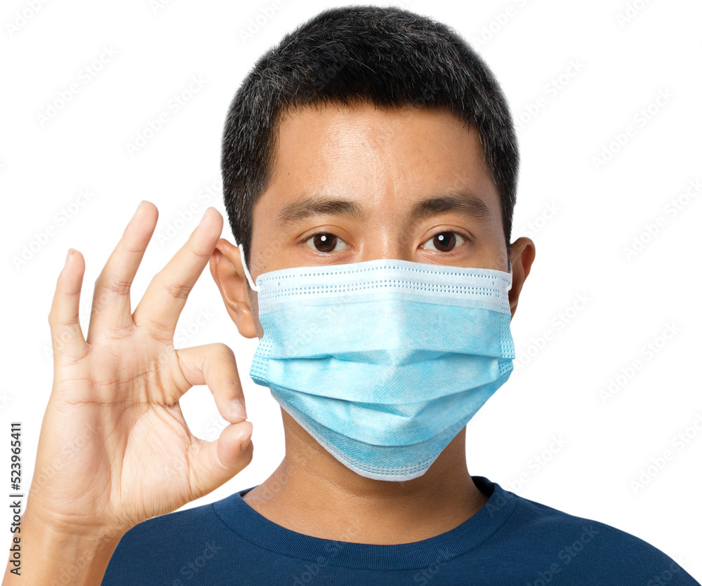young man wearing protective face mask with shows OK sign. young man wearing protective face mask with shows OK sign.