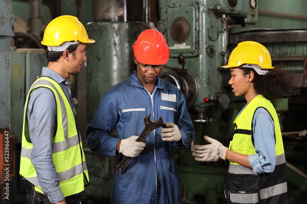 Group of technician engineer team working together discussing, brainstorming and planning work while controll or maintenance operation work lathe metal machine at heavy industry manufacturing factory Group of technician engineer team working together discussing, brainstorming and planning work while controll or maintenance operation work lathe metal machine at heavy industry manufacturing factory