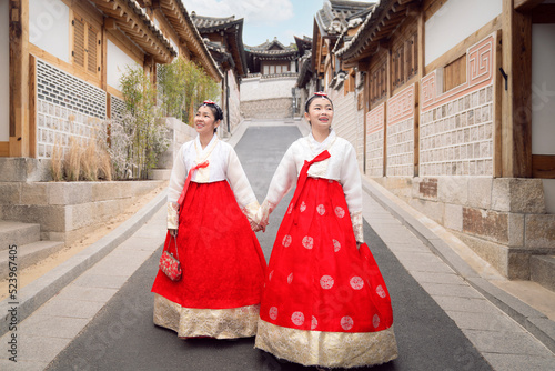 Asian woman traveler in traditional korean dress or hanbok dress photo