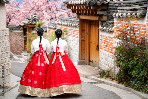 Asian woman traveler in traditional korean dress or hanbok dress photo