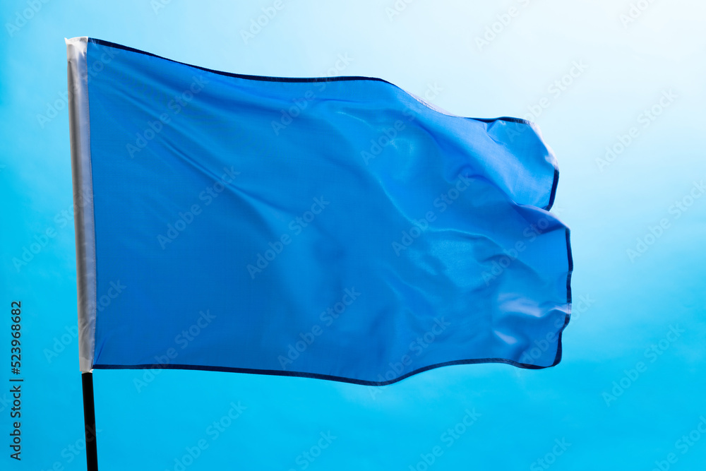 Light blue flag waving on white background