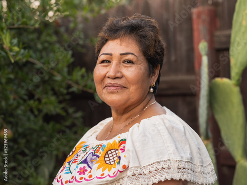 Horizontal image of an older Indigenous woman smiling into the camera 