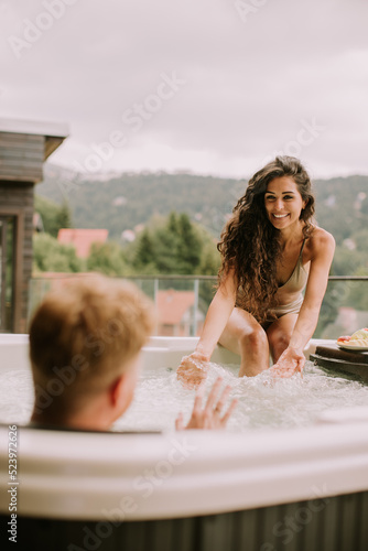 Young couple enjoying in ou...