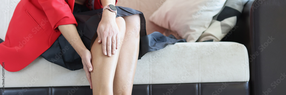 Young woman suffering from leg pain at home - obrazy, fototapety, plakaty 