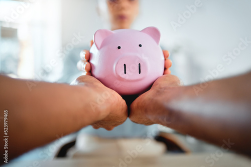 Piggybank, finance and planning savings budget with financial advisor, bank manager and accountant. Closeup of hands holding, taking and protecting future investment after consulting a professional