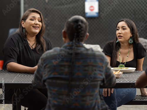 Teacher and students conversing outside