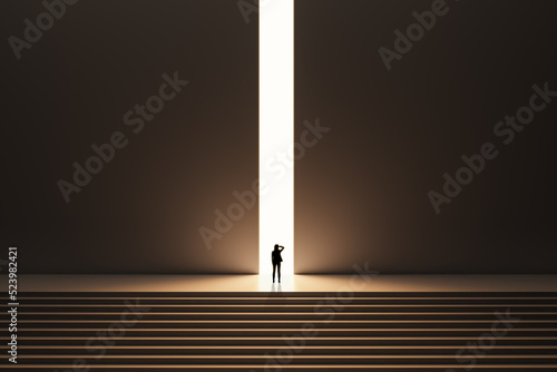 Back view of backlit businesswoman walking on stairs towards bright opening in dark wall. Success, way out, exit and solution concept.