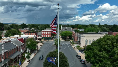 Flags of PA Pennsylvania and USA in town square. Aerial on summer day. photo