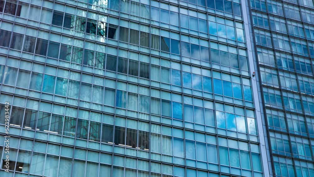 A timelapse of cloud reflecting the building in the business town long shot panning A timelapse of cloud reflecting the building in the business town long shot panning