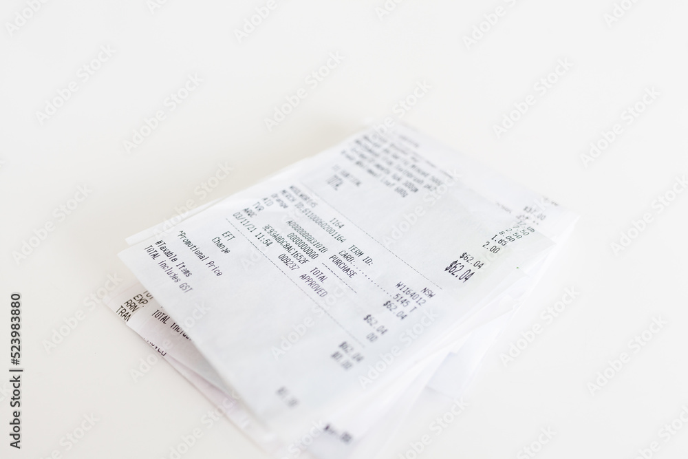 Pile of paper shopping receipts on white