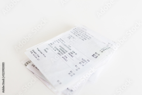 Pile of paper shopping receipts on white photo