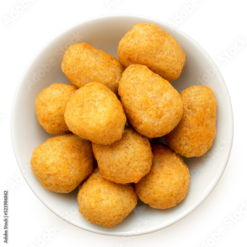Fried breaded chilli cheese nuggets in a white ceramic bowl isolated on white from above.