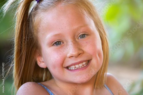 close up of smiling young girl with dimples photo