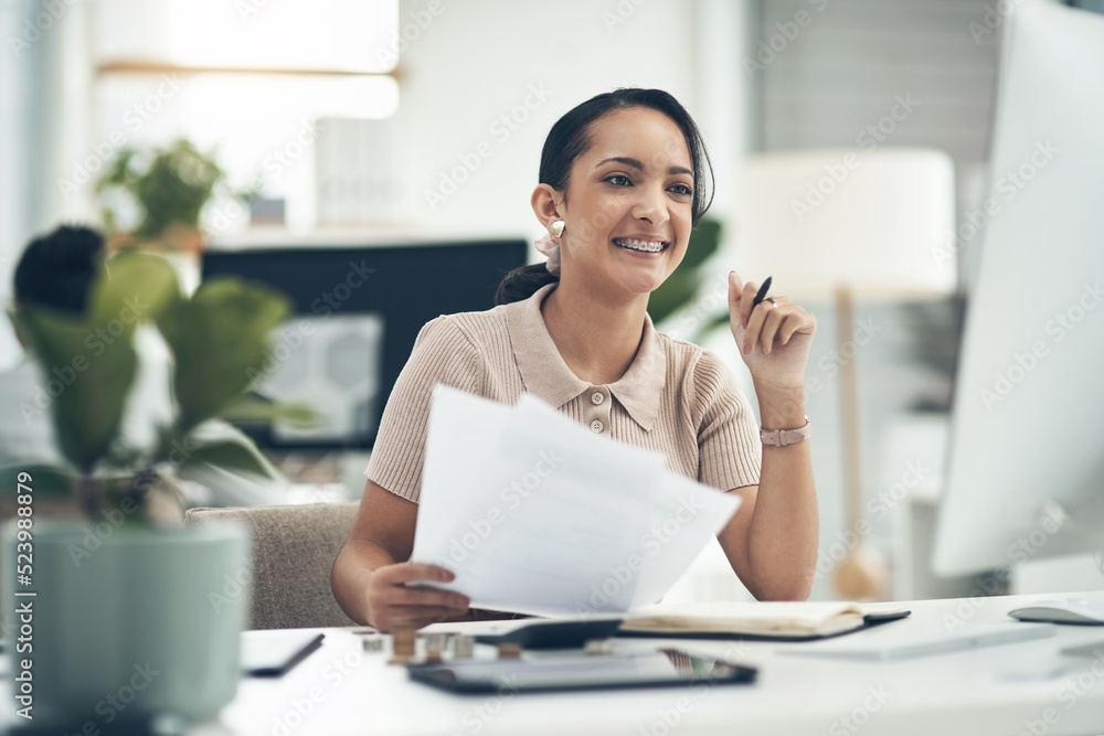 Fototapeta premium Finance manager, businesswoman or financial analyst budgets on a computer with paperwork. Young smiling accountant, insurance advisor or investment planner working on tax, bills or accounting papers