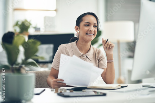 Finance manager, businesswoman or financial analyst budgets on a computer with paperwork. Young smiling accountant, insurance advisor or investment planner working on tax, bills or accounting papers photo