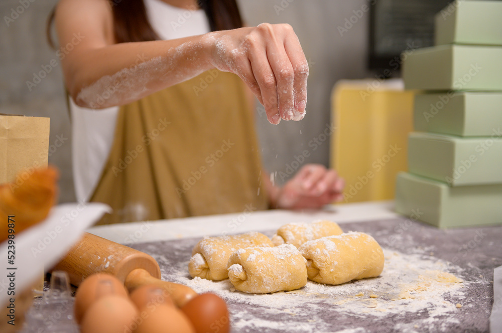 Close up of Young beautiful woman is baking in her kitchen , bakery and coffee shop business