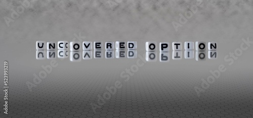 uncovered option word or concept represented by black and white letter cubes on a grey horizon background stretching to infinity