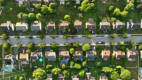 Top down aerial of street with homes in USA. Rooftop view in suburbs in America. American neighborhood community. photo