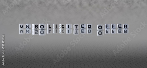 unsolicited offer word or concept represented by black and white letter cubes on a grey horizon background stretching to infinity