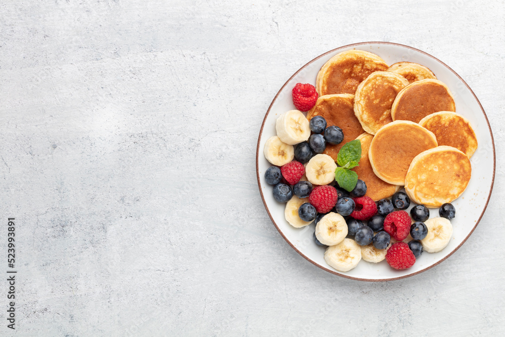 Keto diet pancakes made or almond flour, served with berries. Keto diet pancakes made or almond flour, served with berries.