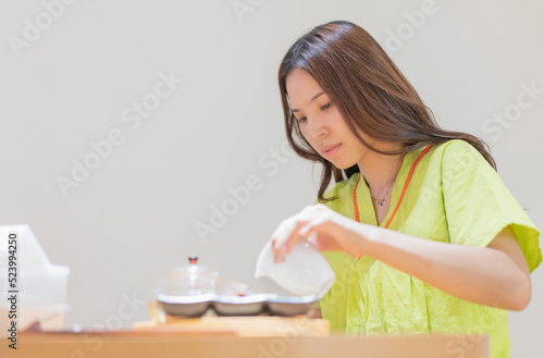 Young Asian women brew health tea in moxibustion health museum