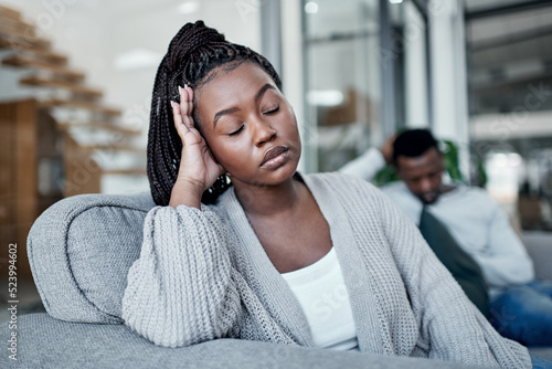 Sad, frustrated and tired woman ignoring husband during a fight, argument and conflict about divorce, breakup and relationship problems. Unhappy, stressed and depressed wife feeling sad in a marriage