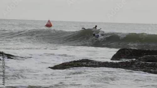 Surfers in action during a bright sunny day. photo