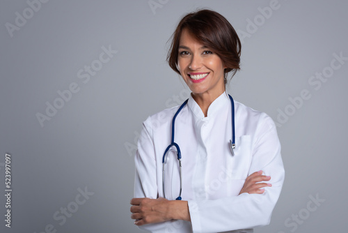 Studio portrait of middle aged female doctor