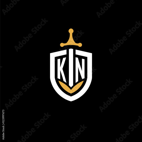 Creative letter KN logo gaming esport with shield and sword design ideas