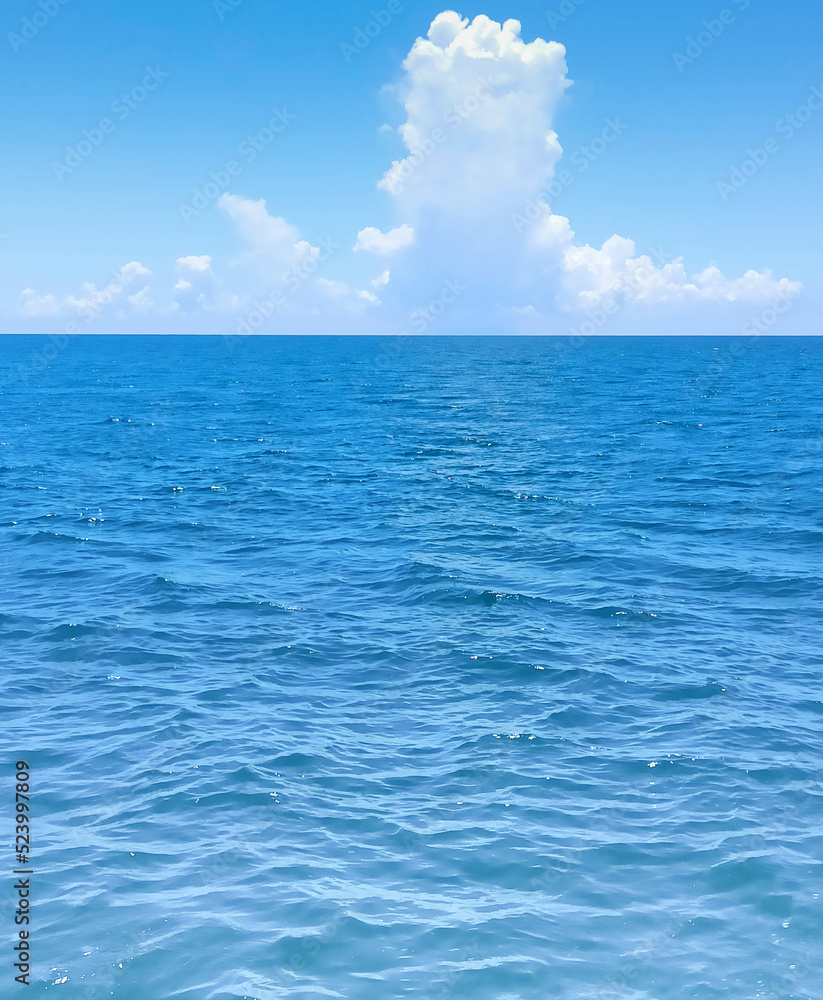 The front view in the morning sky is bright blue with clear white clouds and wide indigo sea during daytime feel calm, refreshing for cool background and copy space above.