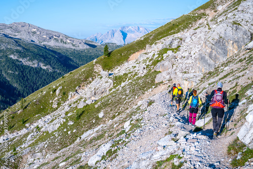 Group of hikers ascending the mountain in Dolomites