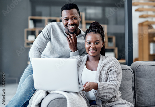 Tableau sur toile Happy couple browsing on a laptop, banking online and applying for a home loan, mortgage bond or insurance