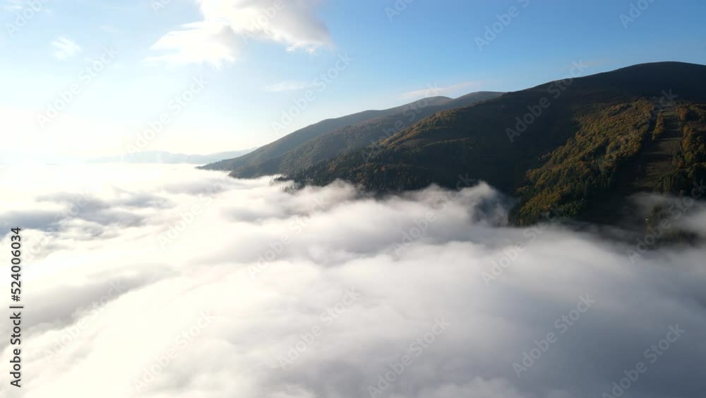 aerial view of autumn carpathian mountains above the clouds