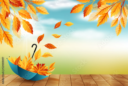 Autumn background with umbrella, flying fall leaves and blue sky