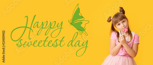 Cute little girl with lollipop on yellow background. Happy Sweetest Day