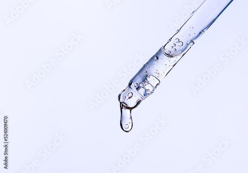 serum pipette close-up with falling drop