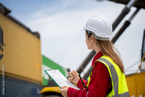 Woman inspector foreman Checking Cargo in Container cargo CustomTerminal port, Foerman use Clipboard paper for checking cargo concept import export transportation and logistic insurance service