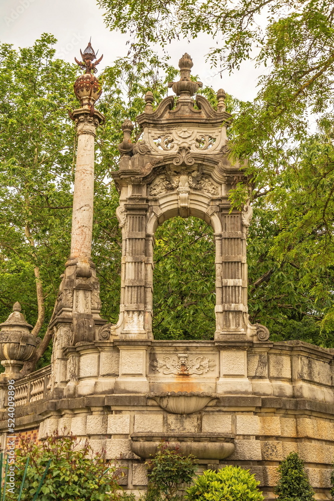 The ruin of an ancient arch with columns in the park The ruin of an ancient arch with columns in the park