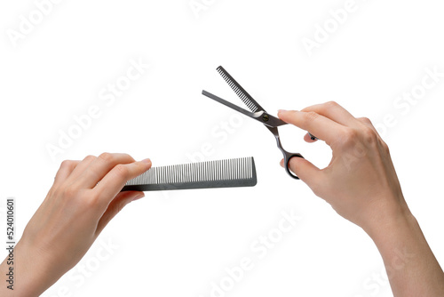 Women's hands hold a comb and thinning scissors. Professional setting of the hairdresser's hands, the position of readiness for the haircut process. Isolated on white background