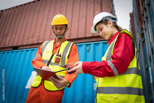 Woman Foreman and Operator Checking Cargo in Container cargo CustomTerminal port, Manager use Tablet for checking cargo concept import export transportation and logistic insurance service