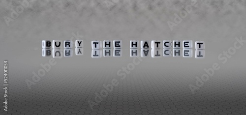 Fotografi bury the hatchet word or concept represented by black and white letter cubes on