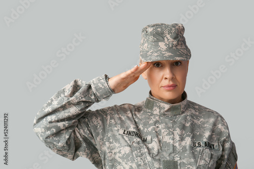 Mature female soldier salut...