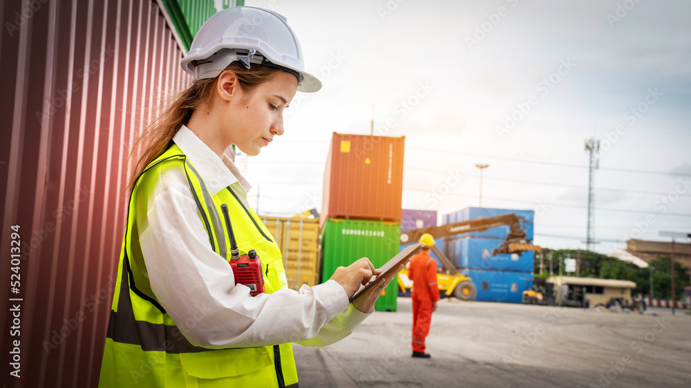 Woman foreman smile at side of Cargo forklift in warehouse , Manager use tablet in white helmet Safety Supervisor in Container Custom Terminal port concept import export Woman foreman smile at side of Cargo forklift in warehouse , Manager use tablet in white helmet Safety Supervisor in Container Custom Terminal port concept import export