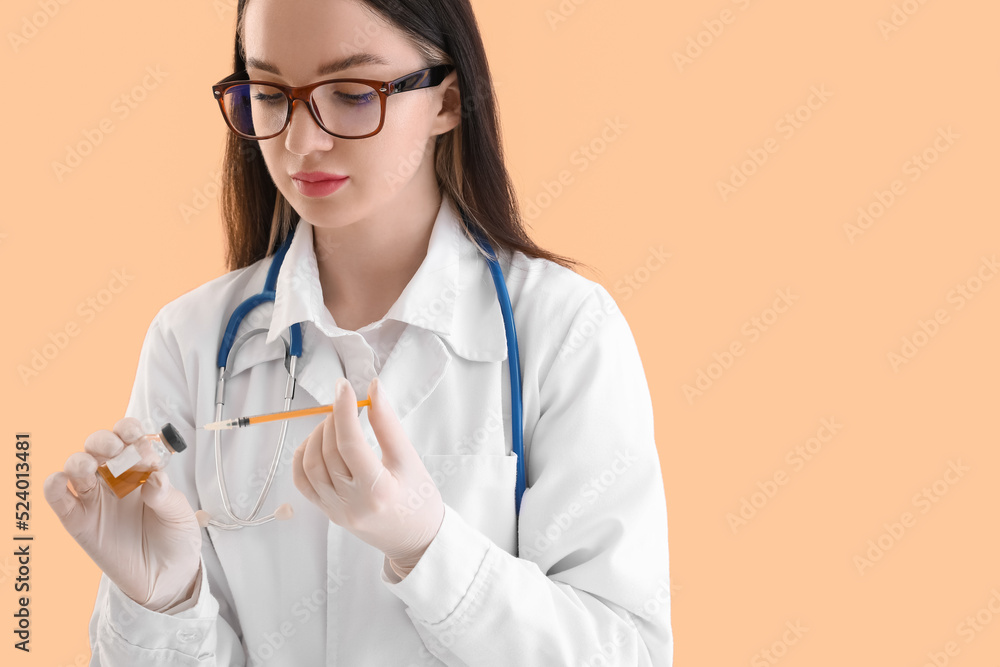 Doctor with ampule and syringe on beige background Doctor with ampule and syringe on beige background