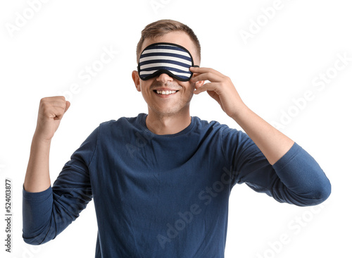 Young man with sleeping mask smiling on white background