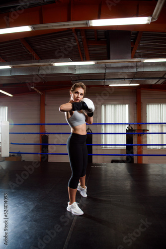 Image of a young athletic woman in boxing gloves.