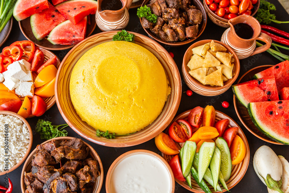 Homemade Romanian Food with polenta, meat, cheese and vegetables. Delicious corn porridge in clay dishes. Mamaliga or polenta, a traditional dish in Moldova, Hungary and Ukrainian cuisine.
Homemade Romanian Food with polenta, meat, cheese and vegetables. Delicious corn porridge in clay dishes. Mamaliga or polenta, a traditional dish in Moldova, Hungary and Ukrainian cuisine.