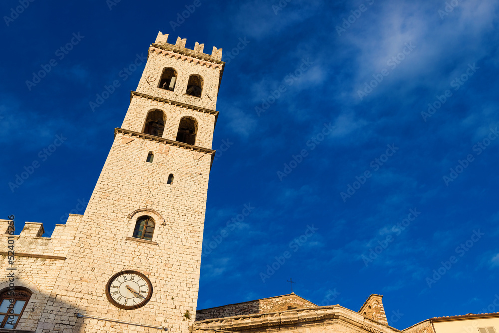 Medieval People's Tower in Assisi Communal Square, a city landmark, with clouds